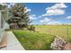Beautiful backyard with mature trees and green lawn at 9431 W Jewell Pl, Lakewood, CO 80227