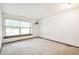 Bright bedroom featuring neutral carpet, a double window, and crisp white walls at 9431 W Jewell Pl, Lakewood, CO 80227