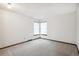 Bright bedroom featuring neutral carpet, a double window, and crisp white walls at 9431 W Jewell Pl, Lakewood, CO 80227