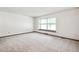 Bright bedroom with neutral carpet and a large window, offering ample natural light and space at 9431 W Jewell Pl, Lakewood, CO 80227