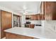 Kitchen with stainless steel appliances, wood cabinetry, and white counter perfect for cooking at 9431 W Jewell Pl, Lakewood, CO 80227