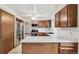Functional kitchen with stainless steel appliances, light countertops, and wood cabinets at 9431 W Jewell Pl, Lakewood, CO 80227