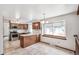 Bright kitchen with wood cabinets, white countertops, stainless steel appliances, and tile flooring at 9431 W Jewell Pl, Lakewood, CO 80227