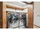 Convenient laundry room with stainless steel washer and dryer at 9431 W Jewell Pl, Lakewood, CO 80227