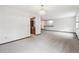 Spacious living room with neutral carpet and easy access to the kitchen and other areas at 9431 W Jewell Pl, Lakewood, CO 80227