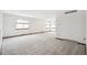 Bright living room with large windows, neutral carpet, and ample space for entertaining at 9431 W Jewell Pl, Lakewood, CO 80227