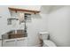 Utility sink with storage and toilet at 9431 W Jewell Pl, Lakewood, CO 80227