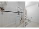 Modern bathroom with white tile, black accent stripe, and glass shower door at 3225 Blake St # 8, Denver, CO 80205