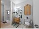 Stylish bathroom featuring a vanity, stone accent wall, and tiled floors at 3225 Blake St # 8, Denver, CO 80205