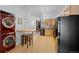 Modern kitchen with wood floors, stainless steel appliances, bar seating, and brick wall detail at 3225 Blake St # 8, Denver, CO 80205