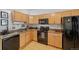 Kitchen features stainless steel appliances, granite counters, wood cabinets, and wood floors at 3225 Blake St # 8, Denver, CO 80205