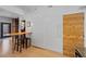 Living area with bar seating, built in storage, and wood panel door at 3225 Blake St # 8, Denver, CO 80205