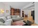 Open living room with exposed brick wall, bicycle decor, comfortable seating, and wood floors at 3225 Blake St # 8, Denver, CO 80205