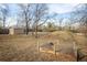 Spacious backyard featuring a storage shed, trees, a garden, and a small hill at 4631 Ashfield Dr, Boulder, CO 80301