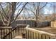 Wooden deck overlooking backyard with a storage shed and trees at 4631 Ashfield Dr, Boulder, CO 80301