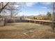 Large backyard with a wooden fence and mountain views in the distance at 4631 Ashfield Dr, Boulder, CO 80301