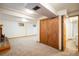 Spacious basement featuring carpet floors, a brick fireplace, and an adjacent bathroom with a glass shower at 4631 Ashfield Dr, Boulder, CO 80301