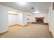 Spacious basement with carpet flooring, a brick fireplace and a bonus room at 4631 Ashfield Dr, Boulder, CO 80301