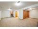 Open basement area with carpet flooring, several doorways, and access to the stairway at 4631 Ashfield Dr, Boulder, CO 80301