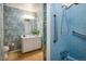 Bathroom with floral wallpaper, a single vanity, and a bright blue tiled shower at 4631 Ashfield Dr, Boulder, CO 80301