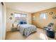 Bedroom with two windows, a blue paisley comforter set and a blue accent chair at 4631 Ashfield Dr, Boulder, CO 80301