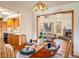 Cozy dining room with warm wood table set, skylight, and view into living room with fireplace at 4631 Ashfield Dr, Boulder, CO 80301