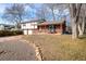 Beautiful home with brick and siding, attached garage, and a cozy front porch with seating at 4631 Ashfield Dr, Boulder, CO 80301