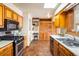 Kitchen with wood cabinets, stainless steel appliances, and a skylight for natural light at 4631 Ashfield Dr, Boulder, CO 80301