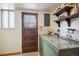 Bright laundry room featuring wooden shelves and a vintage-style washing machine at 4631 Ashfield Dr, Boulder, CO 80301