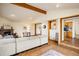 Open-concept living room with hardwood floors, fireplace, and seamless flow to kitchen area at 4631 Ashfield Dr, Boulder, CO 80301