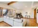 Bright and airy living room with hardwood floors, fireplace, and large windows offering scenic views at 4631 Ashfield Dr, Boulder, CO 80301