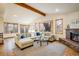 Spacious living room with fireplace, hardwood floors, and large windows bringing in natural light at 4631 Ashfield Dr, Boulder, CO 80301