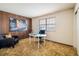 Office space featuring wood-paneled walls, a neutral carpet, and bright natural light at 4631 Ashfield Dr, Boulder, CO 80301