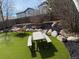 Backyard featuring well-manicured artifical turf, mulch areas, rocks and modern patio furniture at 57 N 45Th Ave, Brighton, CO 80601