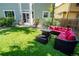 Well-manicured backyard features artificial turf, an outdoor kitchen with grill and patio seating area with modern wicker furniture at 57 N 45Th Ave, Brighton, CO 80601