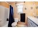 Well-lit bathroom with a shower, toilet, vanity with storage, and a large mirror at 57 N 45Th Ave, Brighton, CO 80601