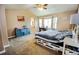 Cozy bedroom with vaulted ceiling, carpeted floors, a large bay window and an en-suite bathroom at 57 N 45Th Ave, Brighton, CO 80601