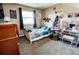 Comfortable bedroom with carpeted floors, a window for natural light, a dresser and a vanity at 57 N 45Th Ave, Brighton, CO 80601