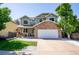 Inviting two-story home with a stone facade, lush lawn, and a convenient two-car garage at 57 N 45Th Ave, Brighton, CO 80601