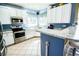 Modern kitchen features stainless steel appliances, tiled floors, and white cabinets at 57 N 45Th Ave, Brighton, CO 80601