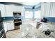 Modern kitchen with white cabinetry, granite countertops, and stainless steel appliances at 57 N 45Th Ave, Brighton, CO 80601