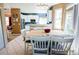 Open kitchen and dining area features stainless steel appliances, white cabinets and tiled floors at 57 N 45Th Ave, Brighton, CO 80601