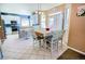 Open kitchen and dining area features stainless steel appliances, white cabinets, breakfast bar and tiled floors at 57 N 45Th Ave, Brighton, CO 80601