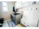 A modern laundry room featuring a bench and ample cabinet storage at 57 N 45Th Ave, Brighton, CO 80601