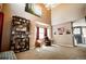 Bright living room with tall ceilings, neutral decor, and a decorative bookshelf at 57 N 45Th Ave, Brighton, CO 80601