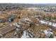 Scenic aerial view of a neighborhood, showcasing houses, streets, open fields, and community buildings at 3695 Quail St, Wheat Ridge, CO 80033