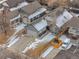 Aerial view of the home showing the roof, driveway, and surrounding neighborhood with light snow cover at 3695 Quail St, Wheat Ridge, CO 80033