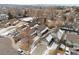 An aerial view of homes showing their roofs, driveways, surrounding streets, and bare trees in winter at 3695 Quail St, Wheat Ridge, CO 80033