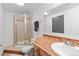 Bathroom featuring tiled vanity, shower, and toilet at 3695 Quail St, Wheat Ridge, CO 80033