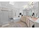 Bright bathroom featuring a glass shower, soaking tub, and double sink vanity with ample countertop space at 3695 Quail St, Wheat Ridge, CO 80033